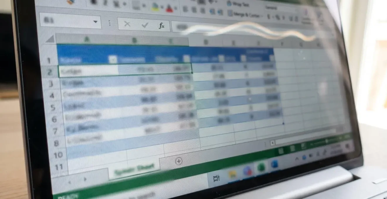 Complex commission spreadsheet with multiple tabs and formulas displayed on a laptop screen